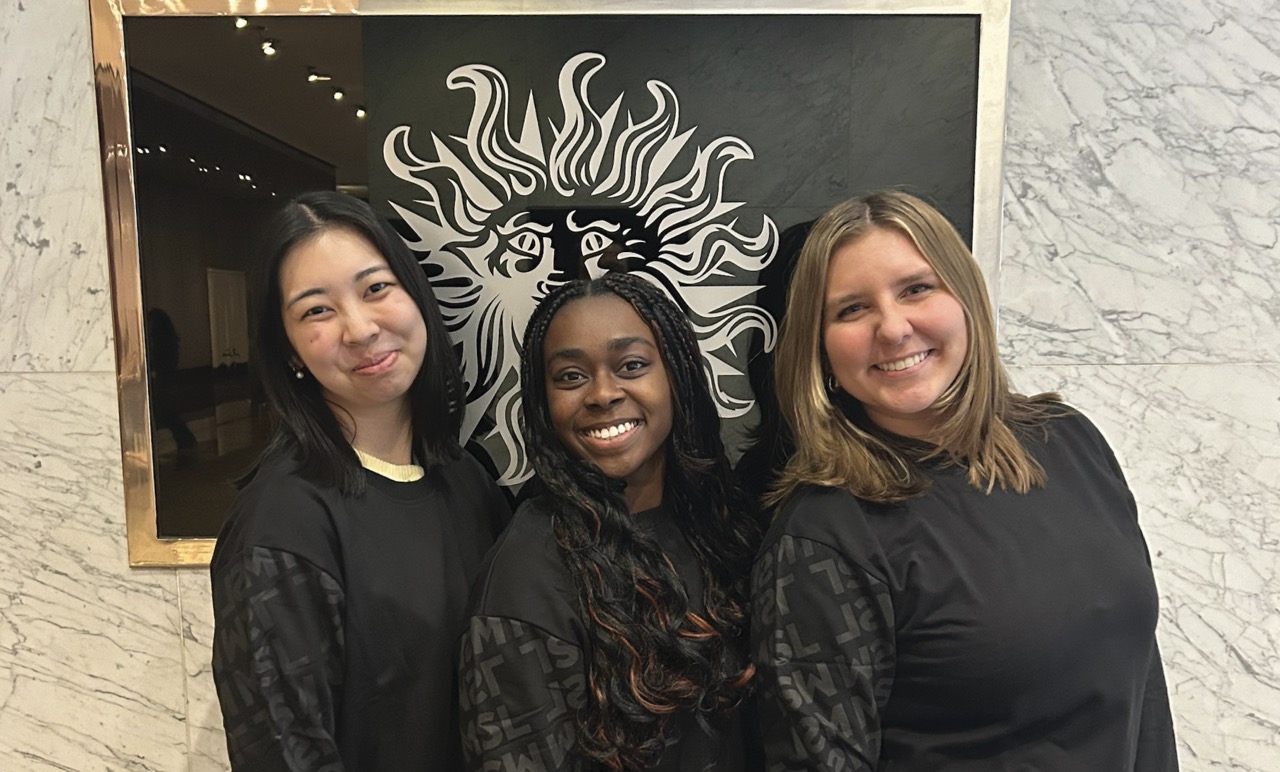 Three of MSL's 2025 Fellows in front of "Publicis Groupe" sign.
